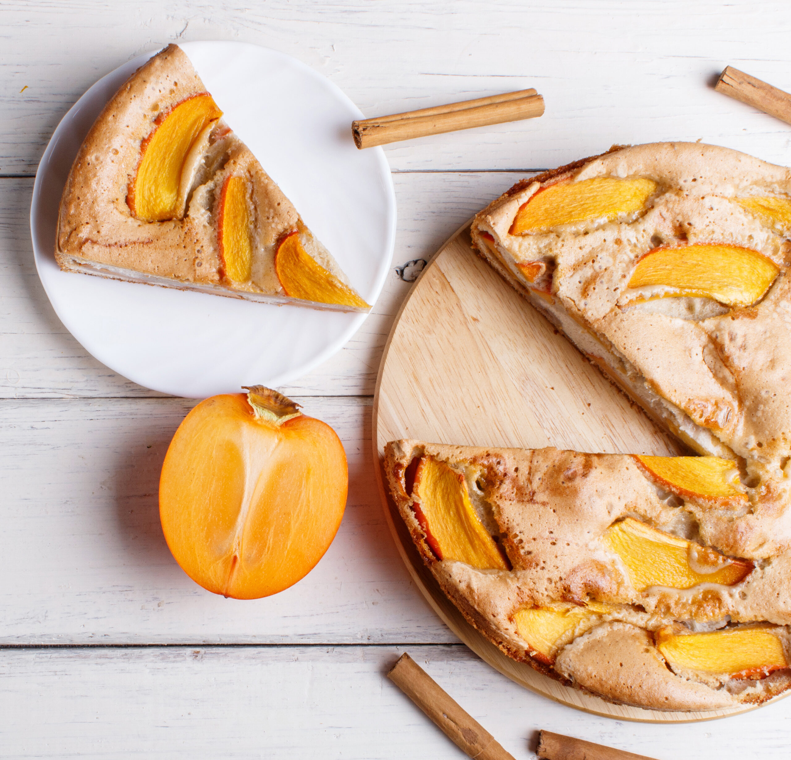 Sweet persimmon pie on white wooden background. top view, copy space.