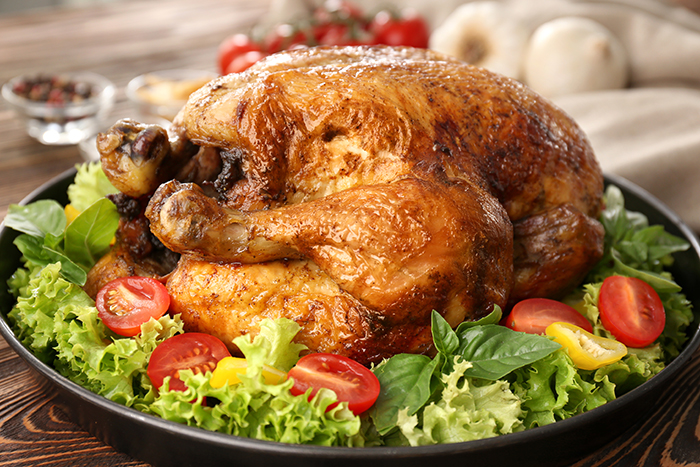 Plate with roasted turkey on table Plate with roasted turkey on table